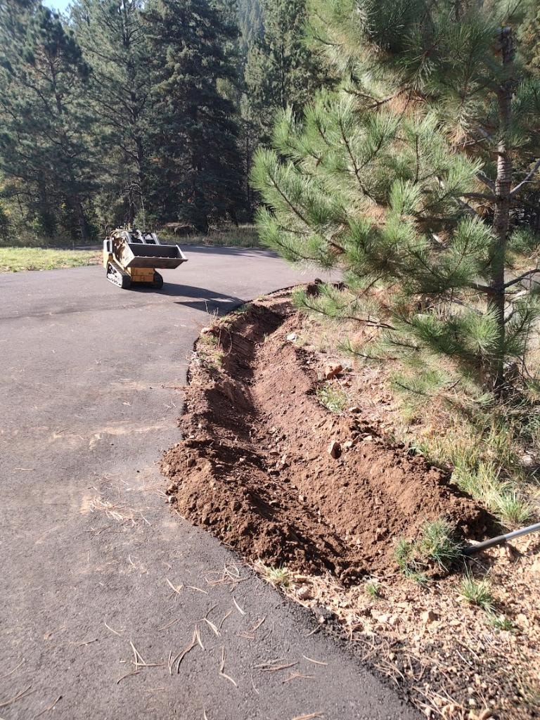 Truck and trailer loaded with felled trees on a mountain property job site